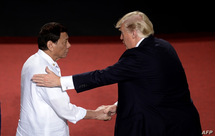 FILE - Philippine President Rodrigo Duterte shakes hands with U.S. President Donald Trump (R) during an Association of Southeast Asian Nations (ASEAN) Summit at the Cultural Center of the Philippines, in Manila, Nov. 13, 2017.
