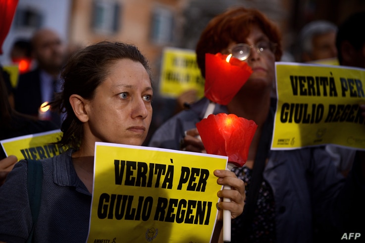 FILE - Amnesty International activists hold a candle light vigil in Rome's Pantheon square, July 25, 2016, in remembrance of the late Italian student Giulio Regeni. 