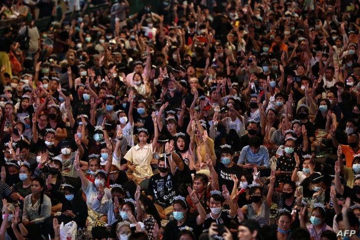 Pro-democracy protesters flash the three-finger salute during a 'Bad Student' rally in Bangkok, Thailand, Nov. 21, 2020.