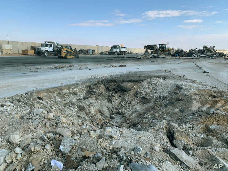 A crater is seen at Ain al-Asad air base, in Anbar, Iraq, Jan. 13, 2020, following an Iranian missile attack. The Pentagon now says 50 U.S. service members have been diagnosed with traumatic brain injury caused by the Jan. 8 attack.