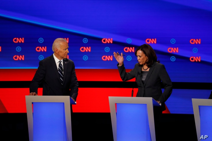 FILE - Sen. Kamala Harris, right, speaks as former Vice President Joe Biden listens during the second of two Democratic presidential primary debates hosted by CNN, July 31, 2019, in the Fox Theatre in Detroit, Michigan.