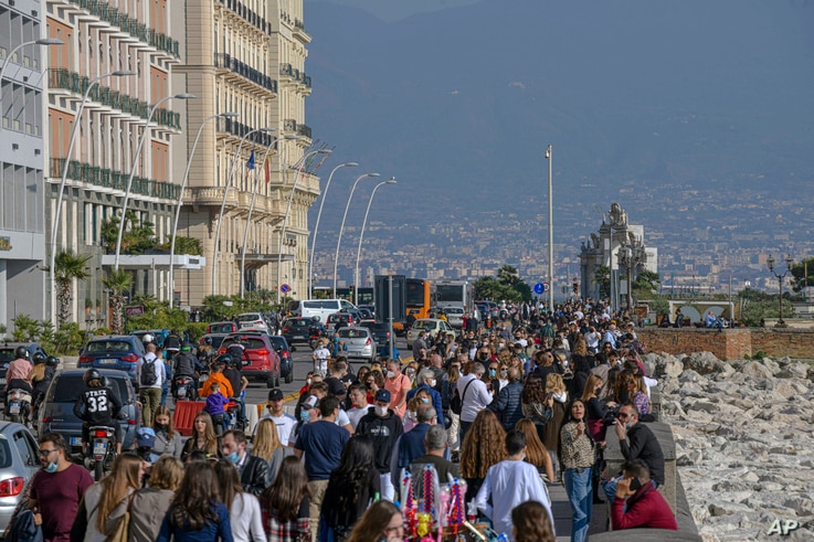 People crowd the Naples waterfront, southern Italy, Nov. 8, 2020.