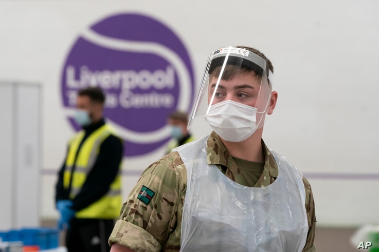 A member of the armed forces waits to test local residents at the Liverpool Tennis Centre on the first day of mass testing pilot, in Liverpool, Britain, Nov. 6, 2020.  
