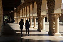 FILE - Students walk on the Stanford University campus in Santa Clara, California, March 14, 2019. 