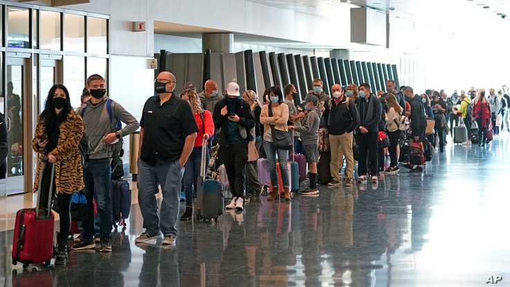 Air travelers line up to go through a security checkpoint at Salt Lake City International Airport in Salt Lake City, Utah.