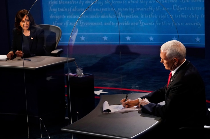 Vice President Mike Pence takes notes as Democratic vice presidential candidate Sen. Kamala Harris, D-Calif., answers a question during the vice presidential debate, Oct. 7, 2020, on the campus of the University of Utah in Salt Lake City.