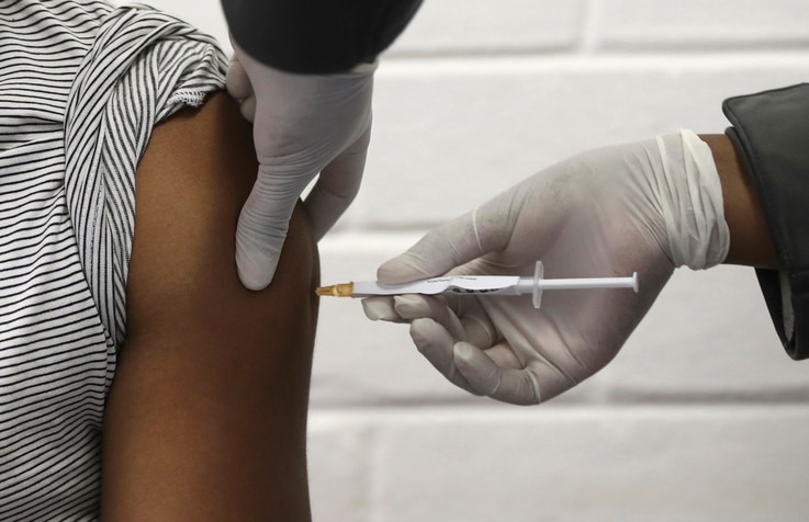 FILE - A volunteer receives an injection at the Chris Hani Baragwanath hospital in Soweto, Johannesburg, South Africa, June 24, 2020, as part of the Oxford/AstraZeneca vaccine trial.