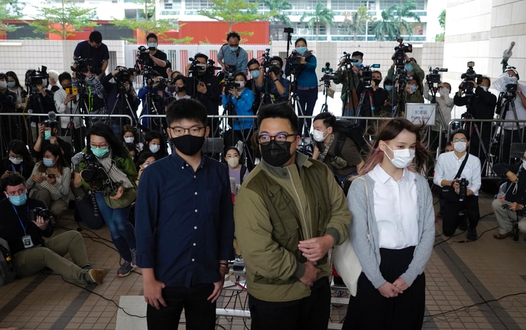 CORRECTS DATE - Hong Kong activists, from left, Joshua Wong, Ivan Lam and Agnes Chow arrive at a court in Hong Kong, Monday,…