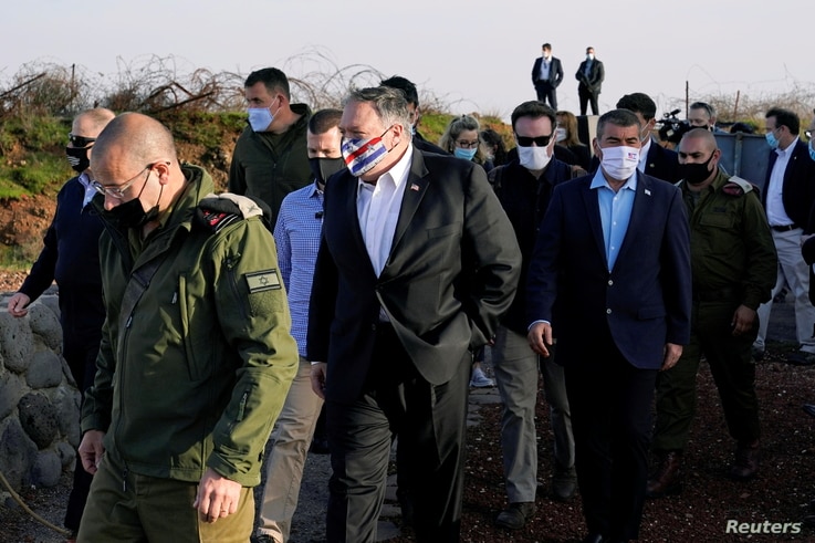 U.S. Secretary of State Mike Pompeo is accompanied by Israeli Foreign Minister Gabi Ashkenazi as they arrive for a security briefing on Mount Bental in the Israeli-occupied Golan Heights, Nov. 19, 2020. 