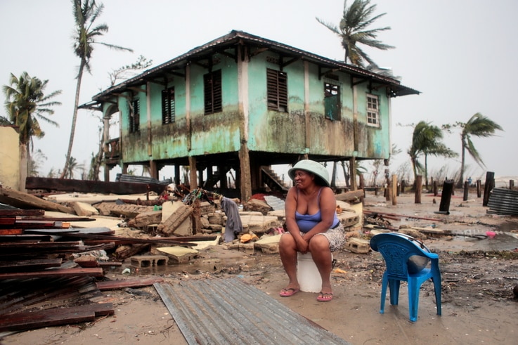 A woman sits near her house damaged the passing of Hurricane Iota, in Puerto Cabezas