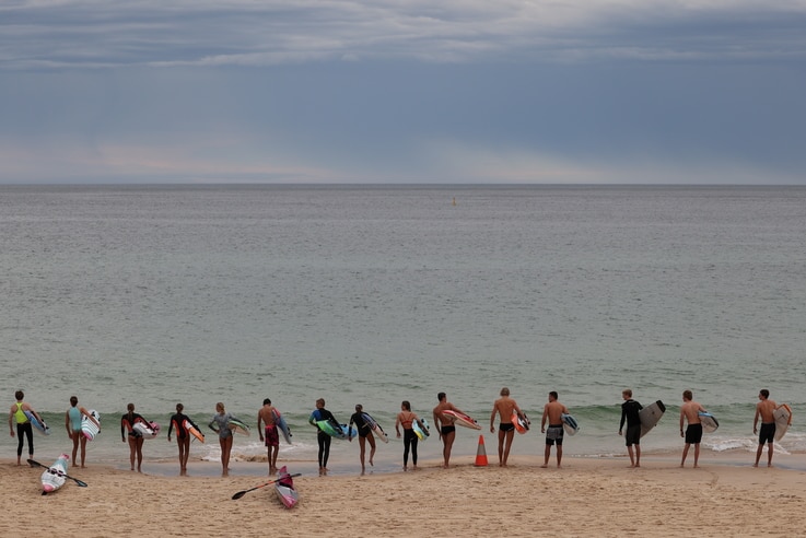 Youths prepare to enter the ocean at Bondi Beach in Sydney