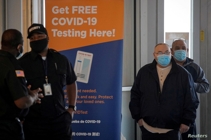 People stand in line to be tested for the coronavirus disease (COVID-19), at a test center at the Staten Island Ferry Terminal in Staten Island, New York, Nov. 12, 2020. 