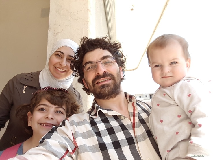 Maimouna al-Ammar, her husband and two daughters pose in a photo taken in 2018 in northern Syria after their displacement from eastern Ghouta near Damascus following a deal between the Syrian government and rebel groups. (Courtesy: Maimouna al-Ammar)