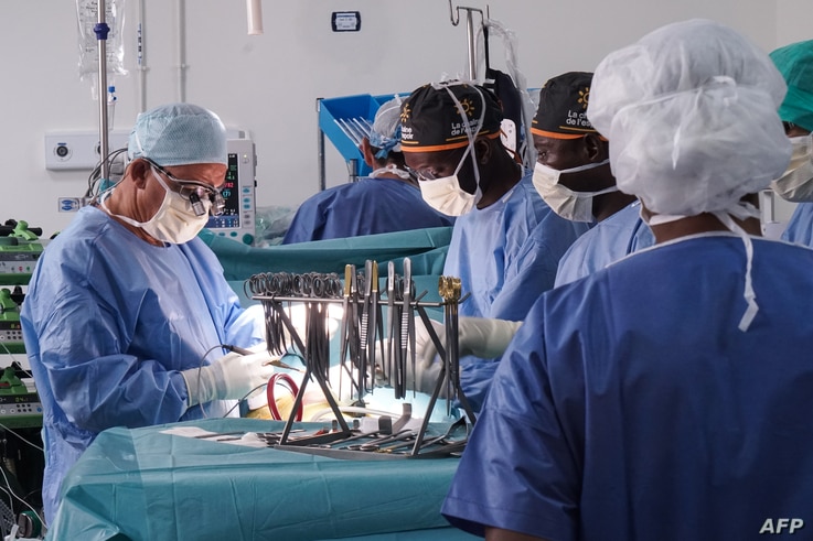 French doctor Olivier Baron, a thoracic and cardiovascular surgeon from the Nantes University Hospital, assisted by Malian…