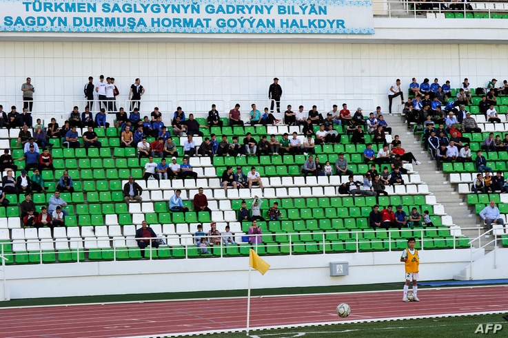 Football supporters attend the Turkmenistan national football championship match between Altyn Asyr and Kopetdag on April 19,…