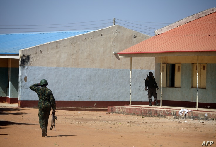 NIgerian soldiers walk inside the Government Science where gunmen abducted students in Kankara, in northwestern Katsina state,…