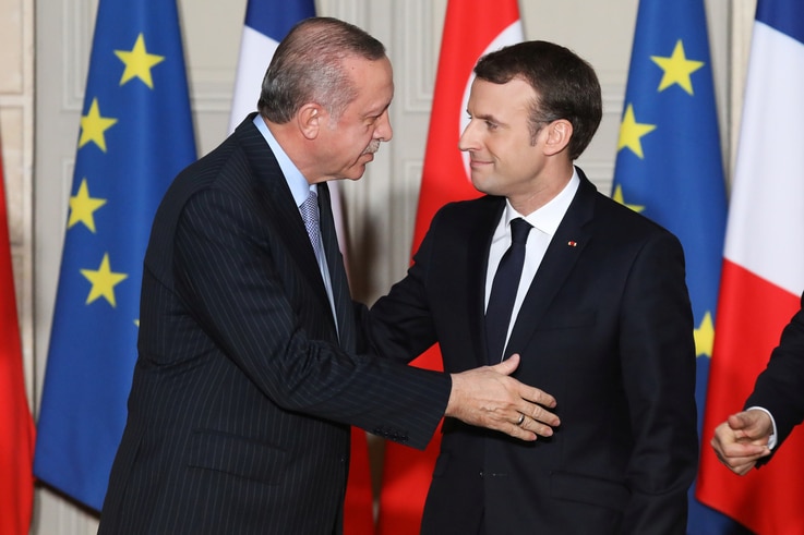 French President Emmanuel Macron greets Turkish President Recep Tayyip Erdogan during a joint news conference at the Elysee Palace in Paris, France, Jan. 5, 2018.
