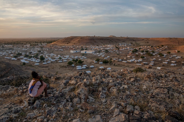 A Tigray girl sits atop a hill overlooking the Umm Rakouba refugee camp, hosting people who fled the conflict in the Tigray…