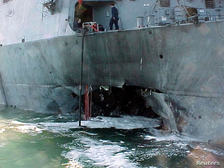 The port side damage to the guided missile destroyer USS Cole is pictured after a bomb attack during a refueling operation in…