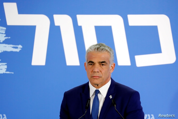 Yair Lapid, head of Yesh Atid holds a news conference together with Benny Gantz, head of Resilience party (not seen) to…