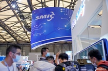 People visit a booth of Semiconductor Manufacturing International Corporation (SMIC), at China International Semiconductor Expo…