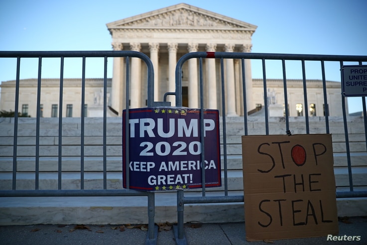 Signs by supporters of U.S. President Donald Trump hang outside the U.S. Supreme Court building in Washington, U.S. November 10…