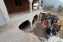 Locals gather near a house, which was damaged, according to them, by cross-border shelling, in Neelum Valley, in Pakistan…