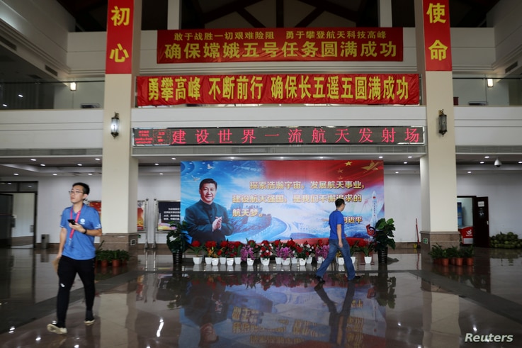 FILE PHOTO: An image of Chinese President Xi Jinping is seen inside a building at the Wenchang Space Launch Center before the…