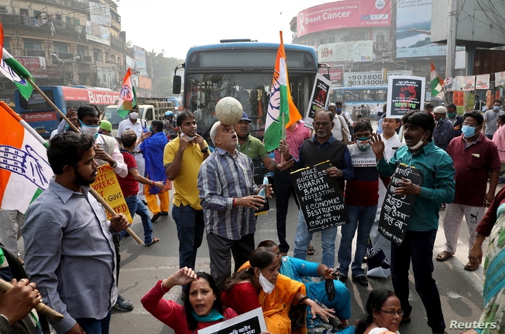 Supporters of India's main opposition Congress party shout slogans and block a road as part of a protest during a nationwide…