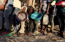 Ethiopian refugees who fled Tigray region, queue to receive food aid within the Um-Rakoba camp in Al-Qadarif state, on the border, in Sudan, Dec. 11, 2020.