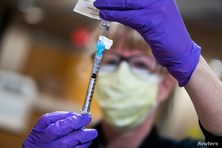 A dose of the Pfizer coronavirus disease (COVID-19) vaccine is prepared at UW Health in Madison, Wisconsin, U.S., December 14,…