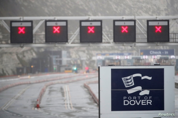 General view of a  closed road and the logo of the Port of Dover at the port as EU countries impose a travel ban from the UK…