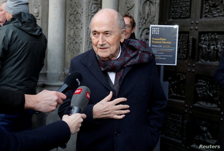 FILE PHOTO: Former FIFA president Sepp Blatter talks to the media as he arrives before a commemoration service for the former…