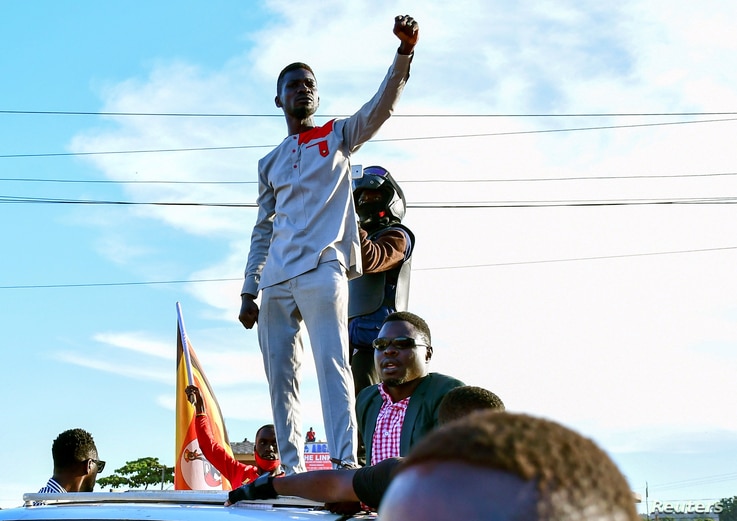 FILE PHOTO: Ugandan pop star and presidential candidate Robert Kyagulanyi, also known as Bobi Wine, campaigns near Kampala,…