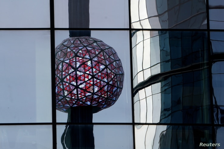 The Times Square ball is reflected in a nearby building as it is tested out for the media ahead of the New Year's celebration…