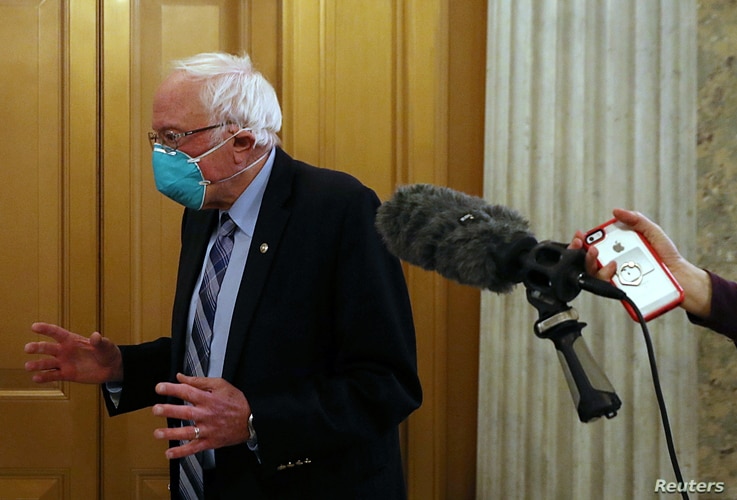 U.S. Senator Bernie Sanders (I-VT) speaks to reporters while leaving the Senate floor as the U.S. Senate face a decision over…