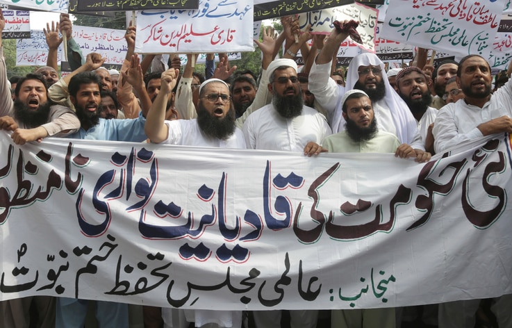 FILE - In this Sept. 7, 2018 file photo, Pakistani Islamists protest the appointment of a minority Ahmadi Muslim as an adviser…