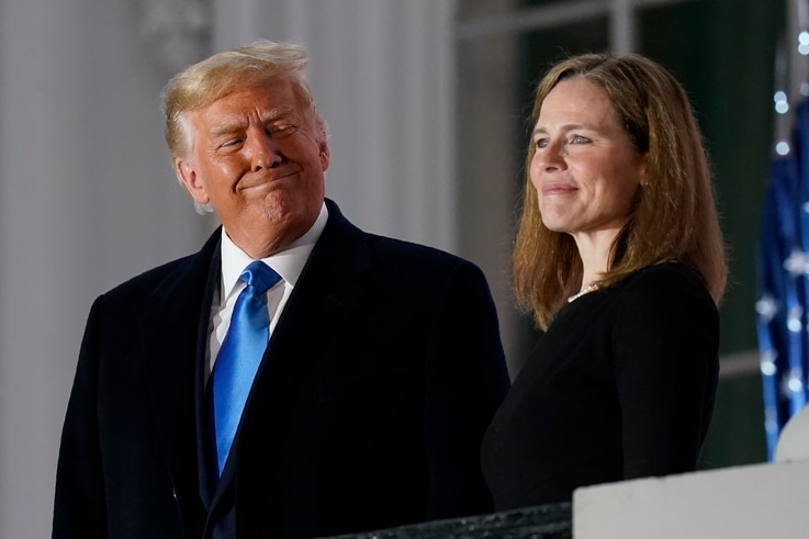 President Donald Trump and Amy Coney Barrett stand on the Blue Room Balcony after Supreme Court Justice Clarence Thomas…