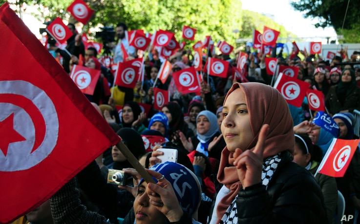 FILE - Tunisians celebrate the fifth anniversary of the Arab Spring, in Tunis, Jan.14, 2016. A new Arab Youth Survey found just five years after the Arab spring, a majority of respondents prioritized stability over democracy in the region. 