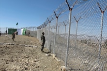 Pakistani soldiers stand guard at a fence between Pakistan and Afghanistan at Angore Adda, Pakistan, Oct. 18, 2017. Pakistan's military says the fencing and guard posts along the border with Afghanistan help prevent militant attacks.