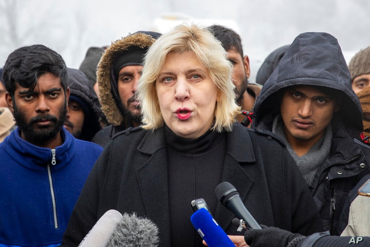 Surrounded by migrants, Dunja Mijatovic, the Council of Europe Commissioner for Human Rights addresses the media at the Vucjak…