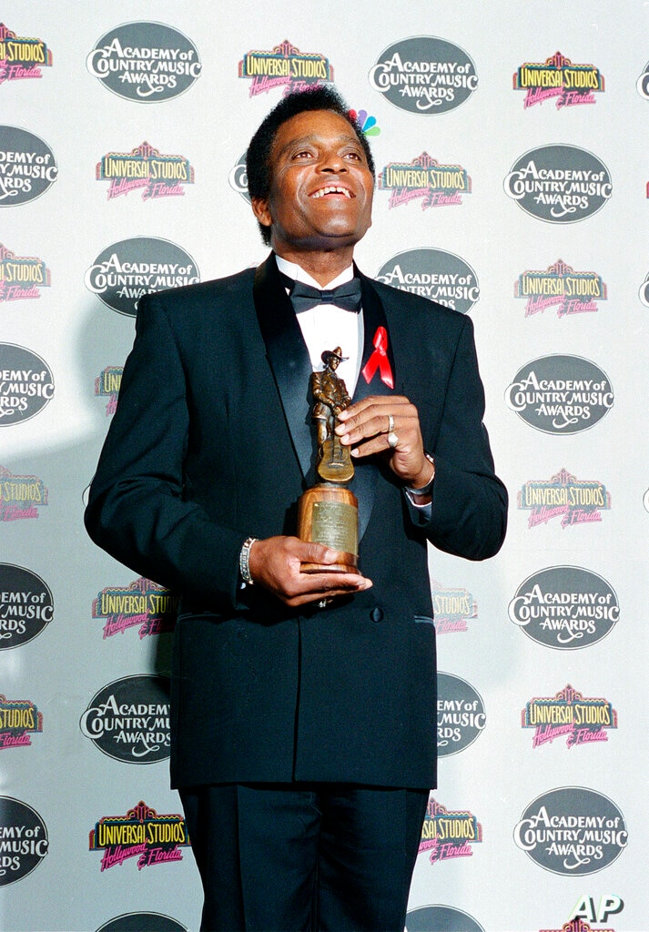 FILE - In this May 3, 1994 file photo, country singer Charley Pride poses with the Pioneer Award he received at the 29th…