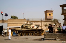 FILE - Egyptian security forces stand guard outside one of the entrances of Tora prison.
