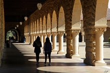 FILE- In this March 14, 2019, file photo students walk on the Stanford University campus in Santa Clara, Calif. Even with a…