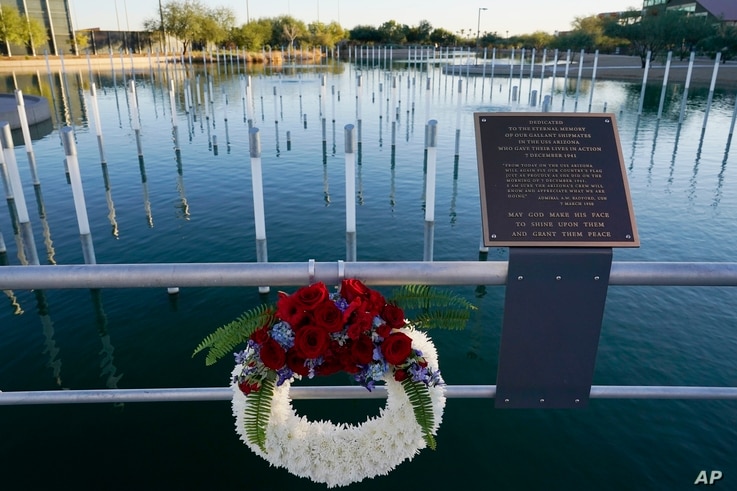 A Veterans Day wreath has been left Wednesday, Nov. 11, 2020, in Scottsdale, Ariz., at the USS Arizona Memorial Gardens.
