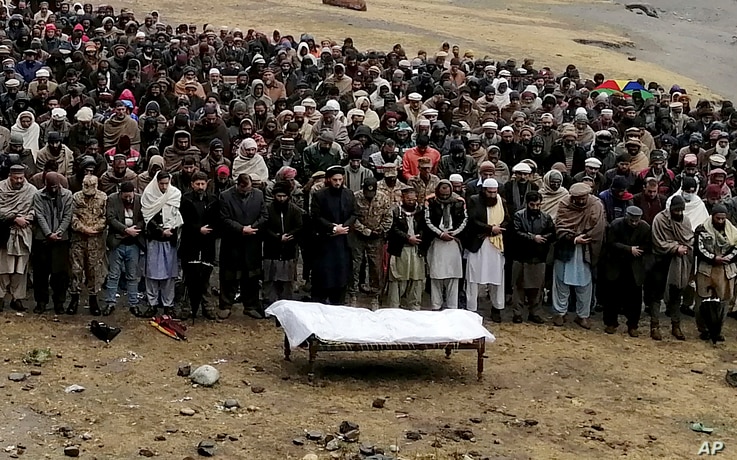 Pakistani Kashmiris attend a funeral prayer of a man, who was reportedly killed by cross border shelling from Indian troops, in…