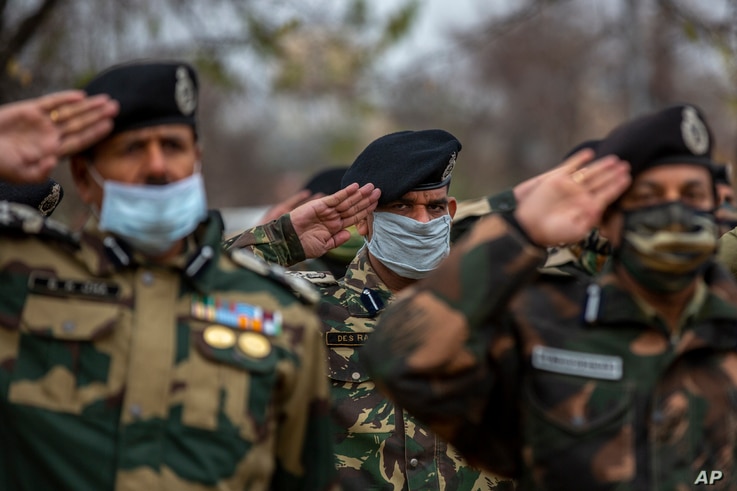 India Border Security Force (BSF) soldiers salute as they pay respect to their colleague killed during Friday’s clash with…