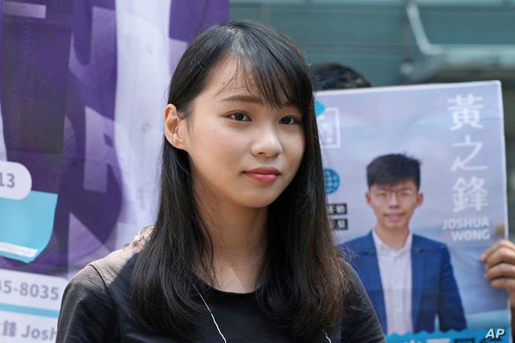 In this Saturday, Sept. 28, 2019, photo, Hong Kong pro-democracy activist Agnes Chow, stands next to an election campaign…