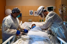 FILE - In this Nov. 19, 2020, file photo, Dr. Rafik Abdou, right, and respiratory therapist Babu Paramban check on a COVID-19…