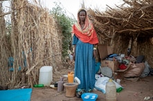 Ethiopian Tigrayan refugee 27-year-old Aksamaweet Garazgerer, who is living with HIV, stands in front of her temporary shelter.